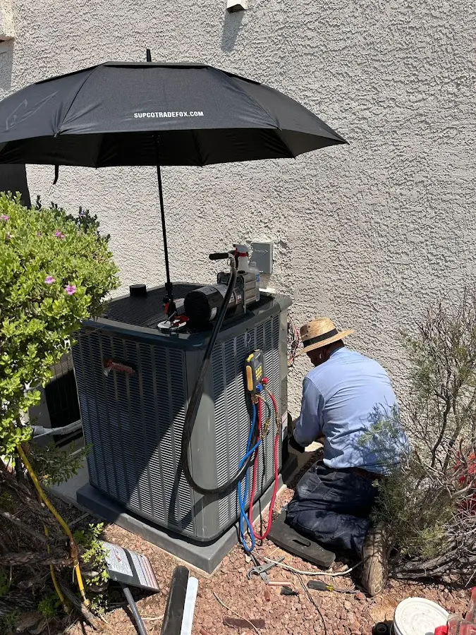HVAC technician performing outdoor AC maintenance in Whitemarsh