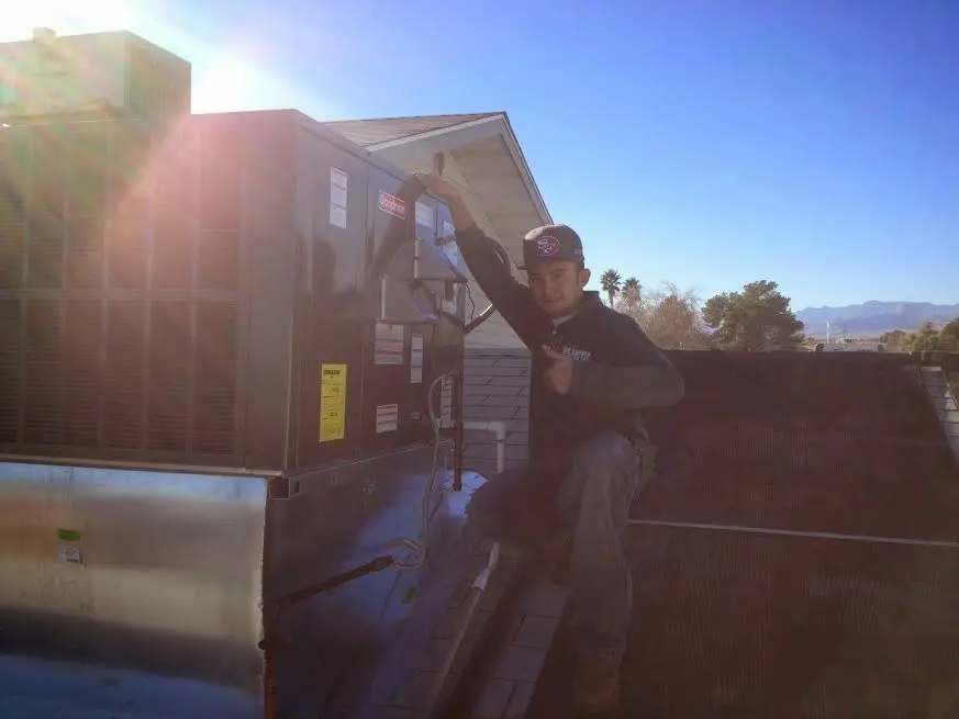 HVAC technician performing Boiler Repair on a rooftop unit in Whitemarsh